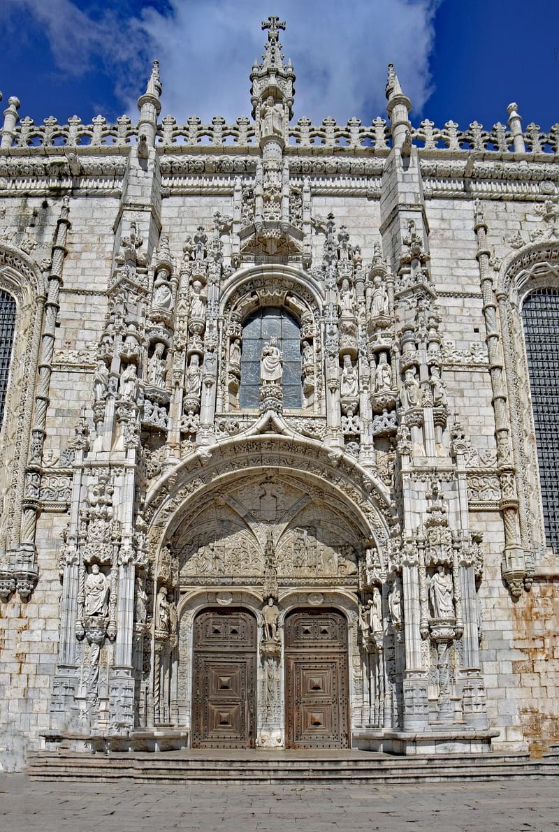 Façade of the Palácio Nacional de Mafra showing the central basilica dome, twin bell towers and 220-metre pink marble front.